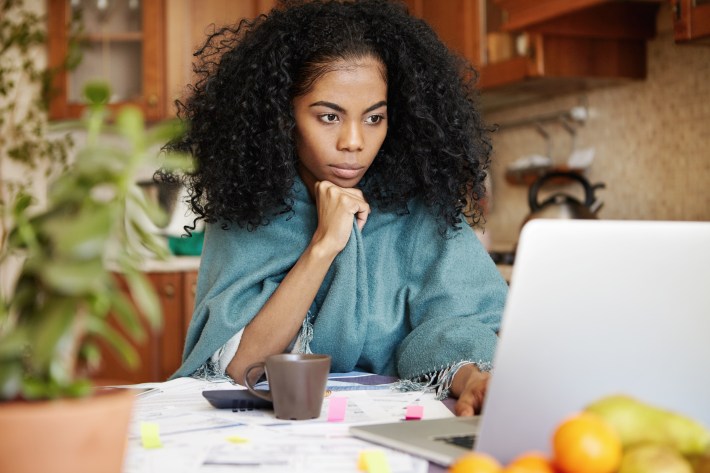 Beautiful African Woman Sitting In Front Of Laptop Computer, Loo