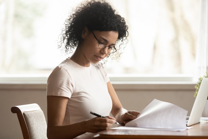 Focused Woman In Glasses Study Correct Paperwork