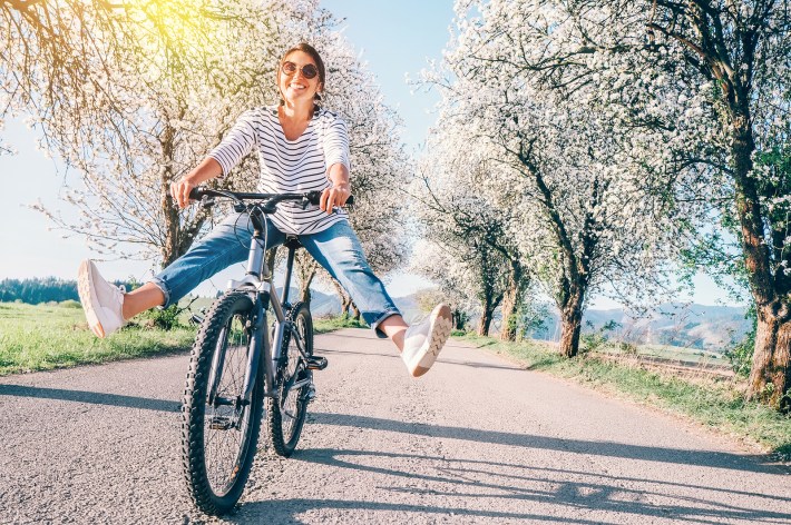 Happy Smiling Woman On Bicycle