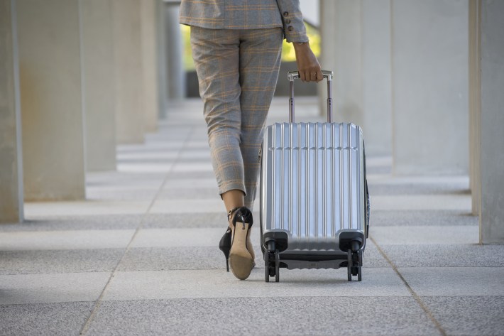 woman business traveler with suitcase